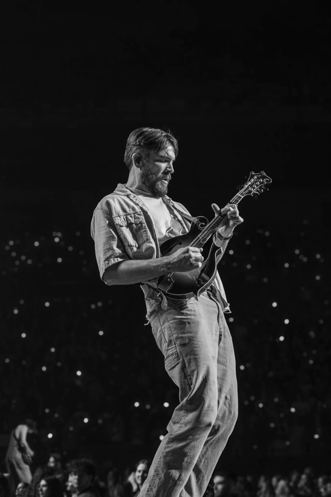Black and white: guitarist mid-stride with a mandolin